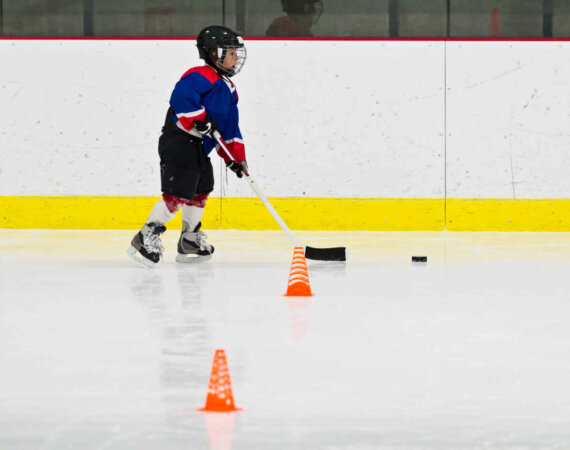 Child Practices Stickhandling At Ice Hockey Practice