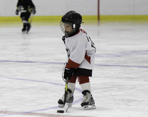 Little Boy Playing Ice Hockey